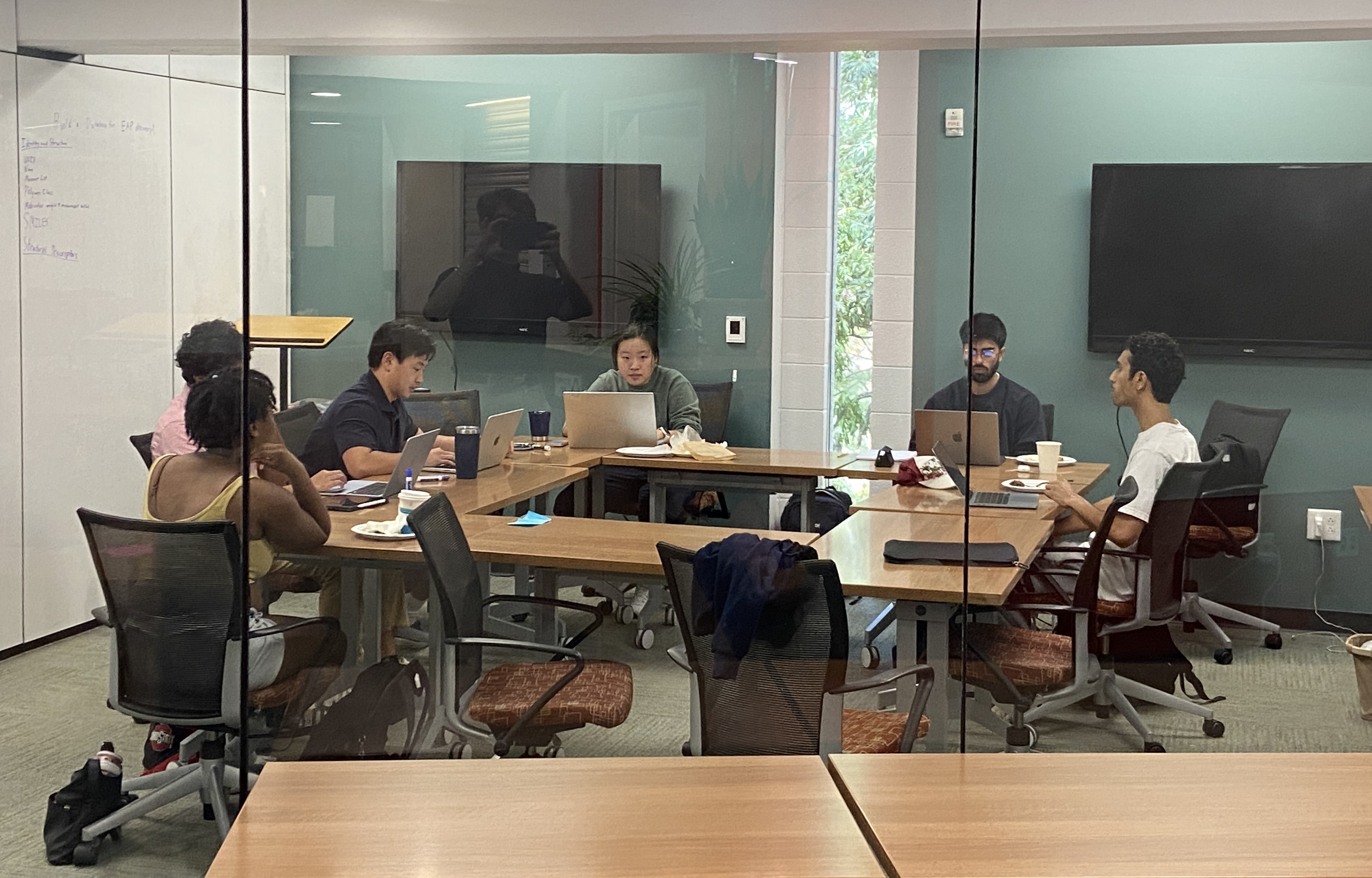 Students work around a conference table.