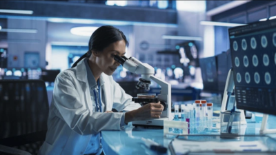 Researcher working on a mircroscope